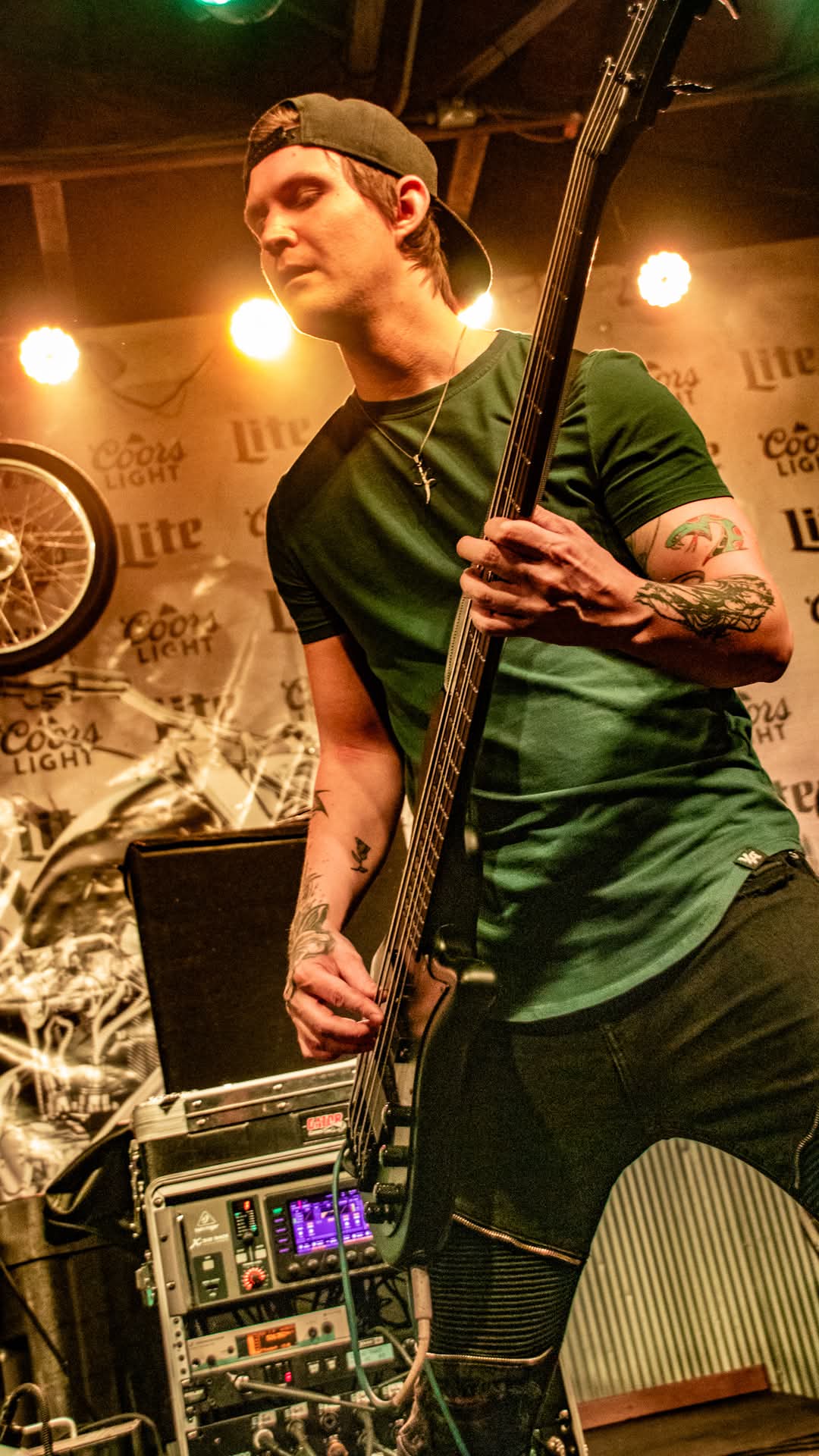 Bassist on stage in front of Coors Light backdrop