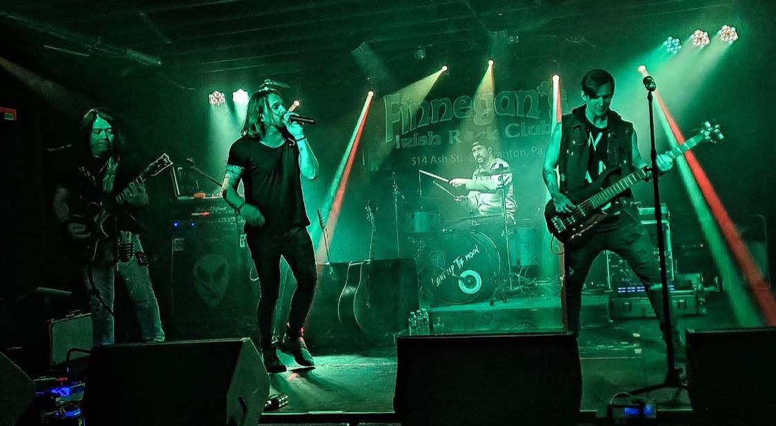 Band performing at Finnegan's Irish Rock Club in Scranton under green lights