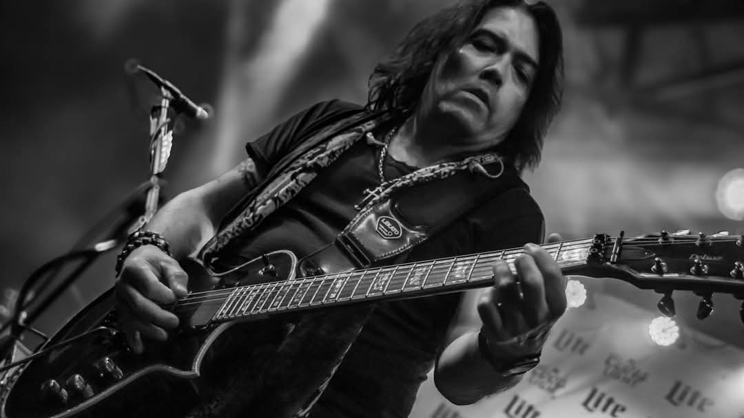 Lead guitarist mid-solo with Les Paul — black and white close-up